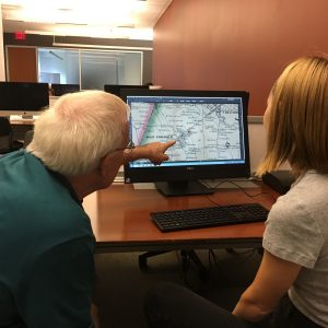 Faculty member showing a digitized map to a student